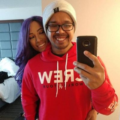 Sasha is looking at the phone standing behind him in this selfie.